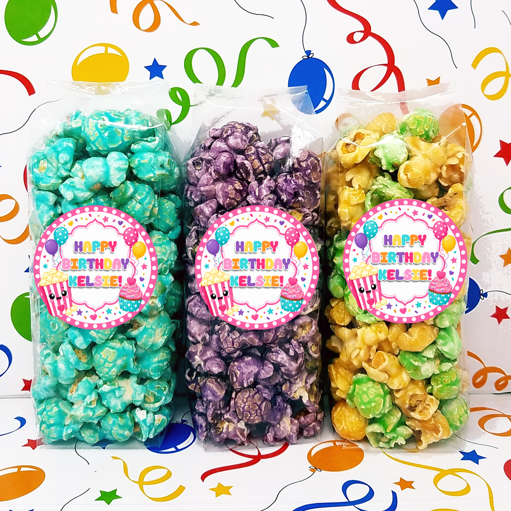 Three bags of colorful popcorn with personalized girly birthday labels.