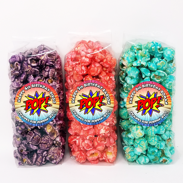 Individual popcorn party favors with personalized superhero labels